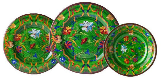 Three colorful, decorative plates with floral and bird patterns arranged in a horizontal line against a white background, embodying the aesthetic research of the Mario Luca Giusti Pancale Green Collection.