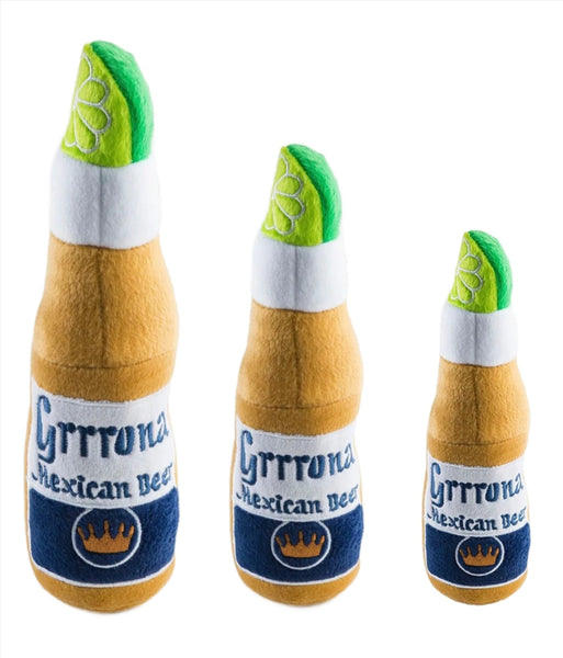 Three plush toys from the Haute Diggity Dog Grrrona Beer Dog Toy Collection designed to resemble bottles of Grrrona Mexican beer, each with a lime wedge at the top.