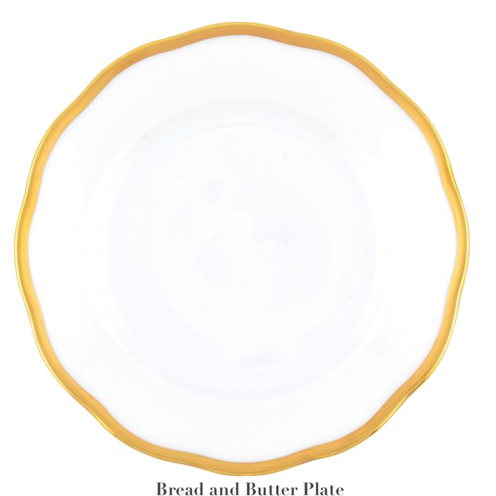 The Herend Gwendolyn White and Gold Collection bread and butter plate features a round white porcelain design with a wavy 24k gold rim—an elegant choice for artistic appreciation at any table setting.