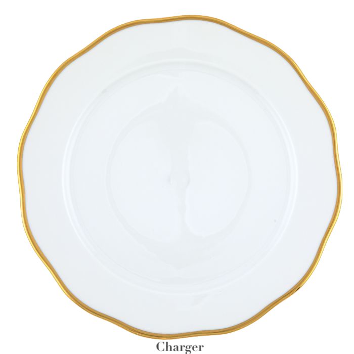 The Gwendolyn White and Gold Collection charger plate by Herend features a wavy rim, elegant white porcelain, and a 24k gold border—an ideal choice for those with refined artistic taste.