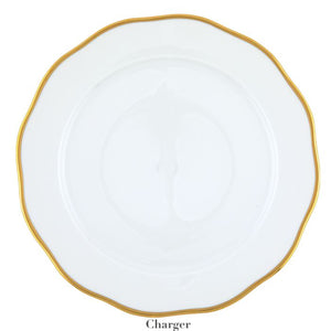 White ceramic plate from the Herend Gwendolyn White and Gold Collection, featuring a wavy 24-karat gold rim and labeled "Charger" on the bottom.
