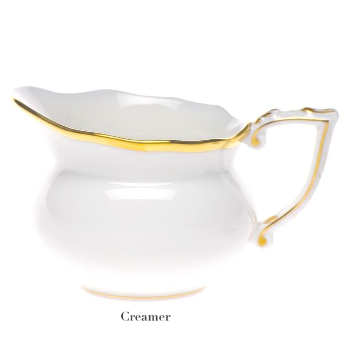 The Herend Gwendolyn White and Gold Collection creamer features white porcelain with a curved handle and 24 karat gold trim, pictured on a plain background with the label "Creamer"—ideal for those who appreciate artistic design.