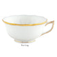 A Herend Gwendolyn White and Gold Collection porcelain tea cup with a scalloped rim and 24k gold detailing on the rim, base, and handle is set against a plain background. The label "Tea Cup" highlights its elegant design.