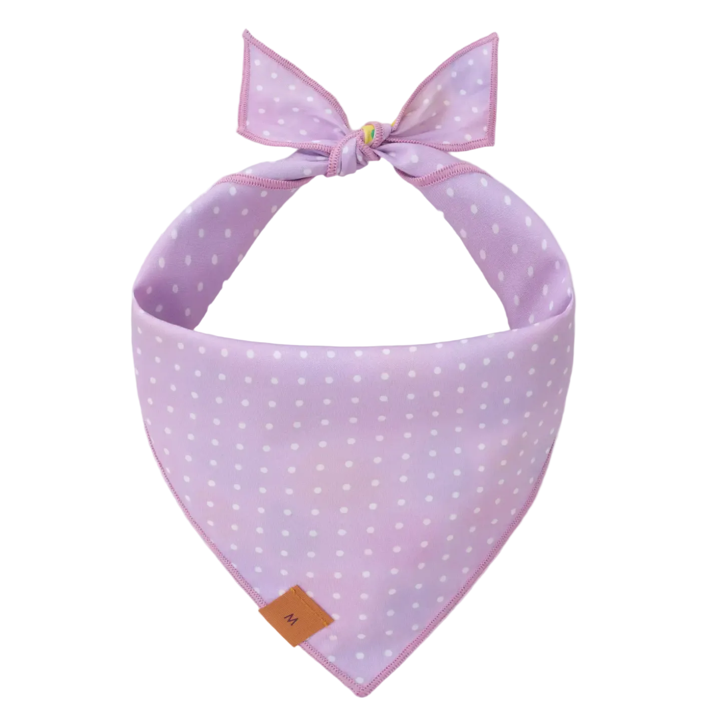 The Foggy Dog's Easter Eggs Reversible Bandana features a light purple fabric with white polka dots, a top tie, and a small brown tag—ideal for spring festivities or Easter egg hunts.