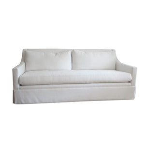 The Hannah Condo Sofa in Nit Witty Sea Salt by Verellen features two back cushions, a long seat cushion, straight arms, and a tailored skirt, creating an inviting focal point for any living room. Set against a white background, its clean lines and subtle elegance are beautifully highlighted by the Sea Salt finish.