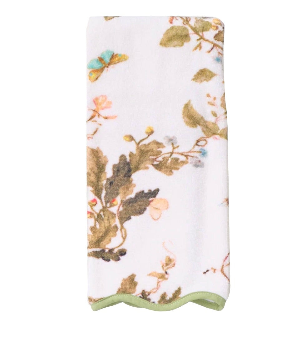 The Vivian Magnolia Floral Scallop Towel by Weezie Towels features a green, brown, and pink botanical pattern with branches, leaves, and a butterfly, plus light green trim and quick-dry terry for added convenience.