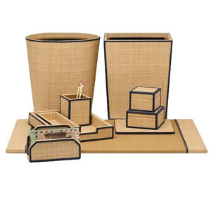 The Hanford Desk Accessory Collection by Pigeon & Poodle features tan and black-trimmed raffia organizers—trash bins, trays, boxes, a pencil holder, and a letter holder—arranged on a matching mat for the Hanford desk.