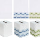 Five Haute Home Mod Bath Collection premium linen tissue box covers, each featuring a different color wavy-line pattern at the base, shown flat and as folded box covers.