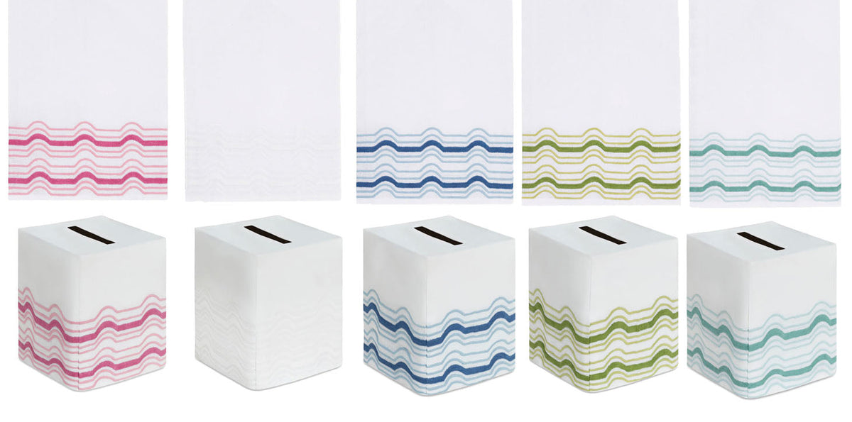 Five Haute Home Mod Bath Collection premium linen tissue box covers, each featuring a different color wavy-line pattern at the base, shown flat and as folded box covers.