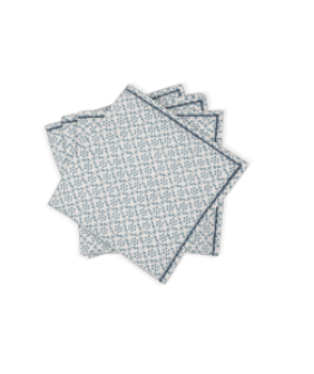 Four neatly stacked square napkins from the Laksha Napkin Set by Matouk, featuring a blue geometric pattern on a white background, reminiscent of block printing in an elegant linen collection.