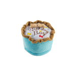 The Haute Diggity Dog Birthday Boy Toy is a plush blue cake-shaped dog toy with "Birthday Boy" embroidered on top, two bone decorations, and a squeaker for extra fun—perfect for celebrating your pup’s special day!.
