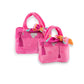 Two small Pink Barkin Bag Dog Toys by Haute Diggity Dog, featuring bright pink plush, embroidered details, and colorful fabric bows on the handles, displayed against a white background.