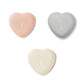 The Aerin Shagreen Heart Box Collection features three heart-shaped boxes in pink, gray, and off-white with embossed shagreen texture, beautifully arranged on a white background—ideal for displaying your jewelry keepsakes.