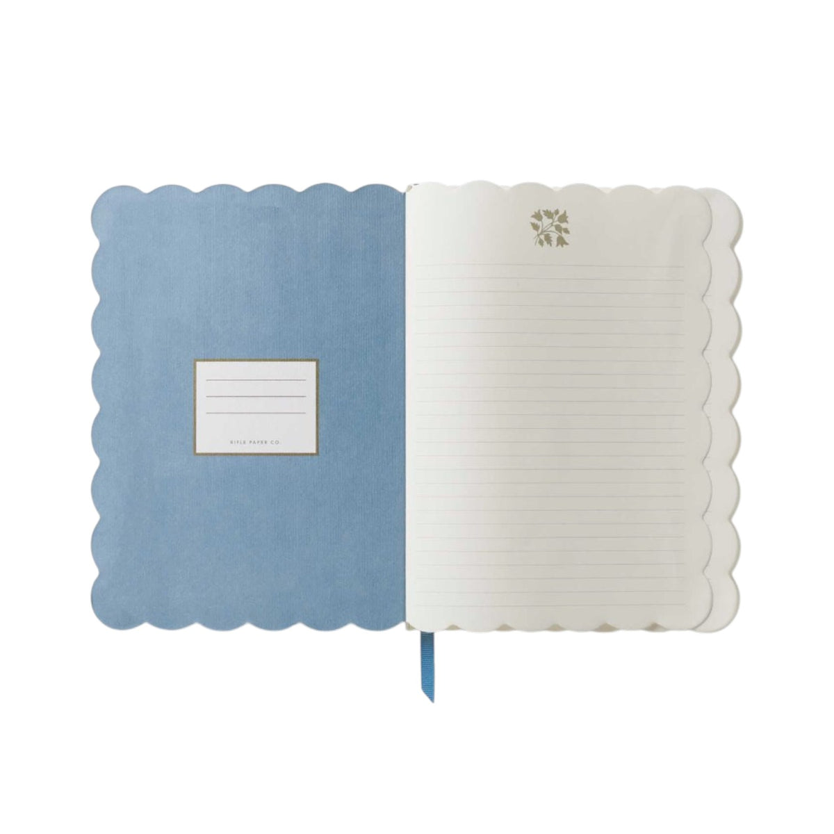 The Helena Softcover Journal by Rifle Paper Co. features an open scallop-edge design, a linen-textured cover, a blue inside cover with a label box, and lined pages each decorated with a small icon at the top.
