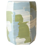 The Hexagonal Garden Stool by Paul Schneider Ceramics features abstract pattern variations in light blue, green, and white.