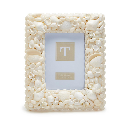 The Two's Company Coquillage Shell Frame, 5x7, features a rectangular design with white seashells and clear gems—ideal for bringing coastal charm to your space.