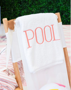 Luxurious Hamburg House Pool Towel with the word "pool" embroidered on a deck chair.