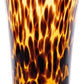 The Juliska Puro Tortoiseshell Drinkware Collection features a tall glass tumbler with a brown and amber tortoiseshell pattern, ideal for serving cocktails or mixing with other pieces from the collection.