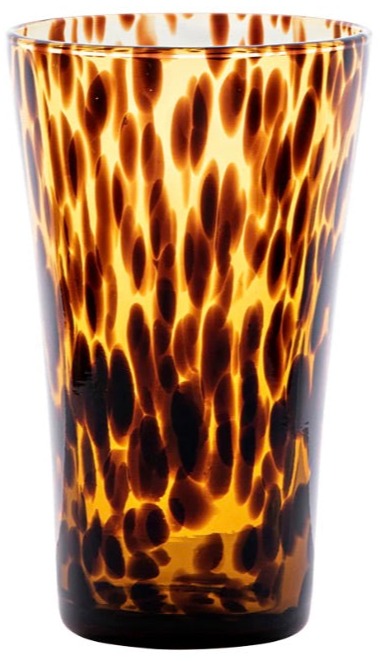The Juliska Puro Tortoiseshell Drinkware Collection features a tall glass tumbler with a brown and amber tortoiseshell pattern, ideal for serving cocktails or mixing with other pieces from the collection.