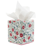 Square Ipsita Coral Tissue Box Cover with a Jaipur hand block floral print of red blossoms and green vines, with a white tissue pulled from the top.