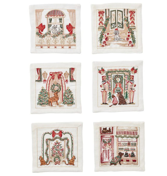 The Kim Seybert Holiday Paws Cocktail Napkins, Set of 6, offer an ideal gift for pet enthusiasts, featuring holiday-themed embroidered linen squares adorned with festive animal scenes, Christmas trees, and decorative holiday imagery.