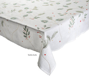 A white Christmas tablecloth from the Kim Seybert Holly & Sprig Linen Collection, featuring a holiday-themed design of green leaves and red berries, reminiscent of embroidered linen.