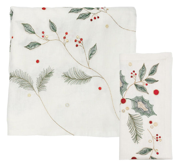 The Kim Seybert Holly & Sprig Linen Collection, crafted by the renowned brand Kim Seybert, features white linen embroidered with green leaves, red berries, and gold accents that exude festive charm. Ideal as a Christmas tablecloth, this collection includes two pieces: one neatly folded and the other gracefully laid out to highlight its intricate holiday greenery pattern.