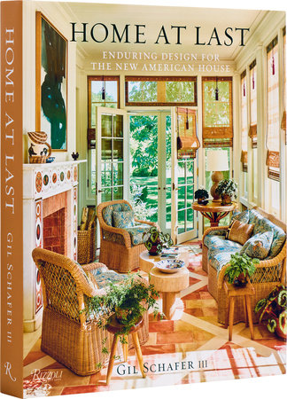 A cozy and vibrant sunroom featured on the cover of "Rizzoli Home At Last: Enduring Design for the New American House" by Gil Schafer III, showcasing architecture and interior design with wicker furniture and greenery in a contemporary traditional style.