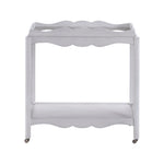 The Lawson Bar Cart by Branch Home features a white wooden frame with scalloped edges, a magnetic tray, an open bottom shelf, and four wheels—perfect for stylishly serving drinks or repurposing as needed.