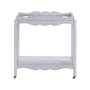 The Lawson Bar Cart by Branch Home features a white wooden frame with scalloped edges, a magnetic tray, an open bottom shelf, and four wheels—perfect for stylishly serving drinks or repurposing as needed.