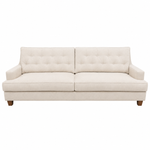The Annabelle Sofa by Hickory Chair is a beige French Moderne tufted sofa featuring a modern-style design, straight armrests, and wooden legs, shown from the front against a white background.
