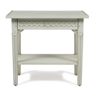 The Inge Side Table by Bunny Williams features a white wooden frame, decorative lattice design, lower storage shelf, and a charming hand-painted Swedish finish.
