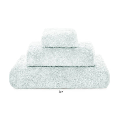 Three neatly stacked pale blue towels of different sizes from the Egoist Bath Collection by Graccioza, crafted from high density Egyptian cotton, displayed on a white background.