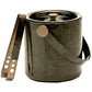 The Nelson Gray Barware Collection by Blue Pheasant features a marble-inspired black ice bucket with a metallic lid, side handle, and matching gold ice tongs resting on the side, all accented with elegant brass detailing.