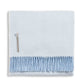 Alicia Adams Alpaca Classic Herringbone Throw, light blue with soft fringe and fabric label, fair-trade made in Peru, displayed folded on a white background.