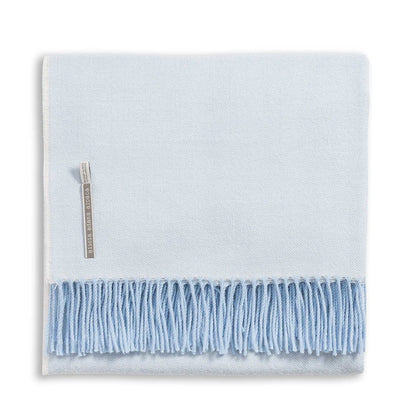 Alicia Adams Alpaca Classic Herringbone Throw, light blue with soft fringe and fabric label, fair-trade made in Peru, displayed folded on a white background.