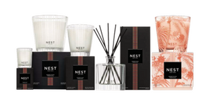 Discover the Nest Something Tropical Candle and Diffuser Collection, presented in glass containers with vibrant black and pink packaging and featuring enticing tropical notes.