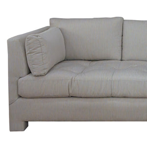 The Barrett Sofa in Ticking Stripe Dove by Highland House features gray and white ticking stripe upholstery, tufted seat cushions, and a matching rectangular pillow for a coastal-inspired look, displayed here from an angled side view.