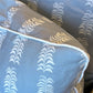 Close-up of HIVE's Petite Frond Blue Pillow, featuring white leaf-like patterns and white piping on light blue fabric, crafted from premium materials for lasting comfort.