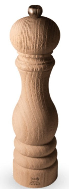 A tall, wooden Paris Nature Wood Salt and Pepper Mill Collection with a ribbed design and a rounded top, featuring a stainless steel mechanism, isolated on a white background by Peugeot Saveurs.