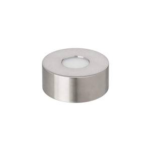 The Simon Pearce Illumination Base, a round silver metal tealight holder with a white candle inside, sits on a plain white background—ideal for pairing with LED lighting to highlight its elegant simplicity.