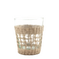 The Be Home Seagrass Cage Glassware Collection features clear glass cups with woven seagrass sleeves, perfect for stylish cocktails or bringing artisanal flair to your drinkware.