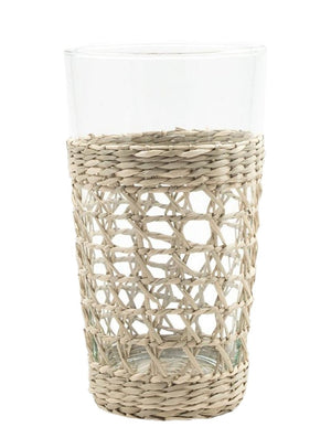 The Be Home Seagrass Cage Glassware Collection features clear glass tumblers partially wrapped in woven seagrass—ideal for cocktails or bringing a stylish touch to your everyday drinkware.