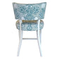 The A. Rudin Counter Stool in Turquoise Shell Grato features white wooden legs and a patterned turquoise and white seashell upholstered seat and backrest, seen from the rear.