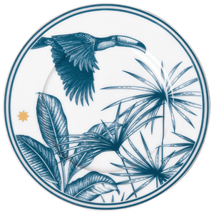 The Furstenberg Paraiso Blue Collection plate features a blue toucan flying above tropical plants and a small gold star near the edge, crafted from high-quality materials.
