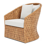 The Indra Lounge Chair by Made Goods features a rounded back, woven rattan-style frame, and light beige seat and back cushions in a swivel wicker design.