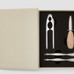 The PrintWorks Seafood Tool Set includes a shell cracker, a wooden-handled oyster knife, and two metal forks, all neatly arranged in a fitted foam insert.