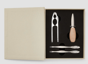 The PrintWorks Seafood Tool Set includes a shell cracker, a wooden-handled oyster knife, and two metal forks, all neatly arranged in a fitted foam insert.