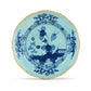 The Oriente Italiano Iris with Gold Dinnerware Collection by Ginori 1735 features blue and white porcelain plates with floral and geometric patterns, scalloped edges, and gold trim, showcasing Italian elegance and exquisite craftsmanship.