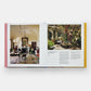 Displayed open is *Italian Interiors: Rooms with a View* by Phaidon, featuring an Italian interior design on the left page and an outdoor garden scene with a large tree on the right page.